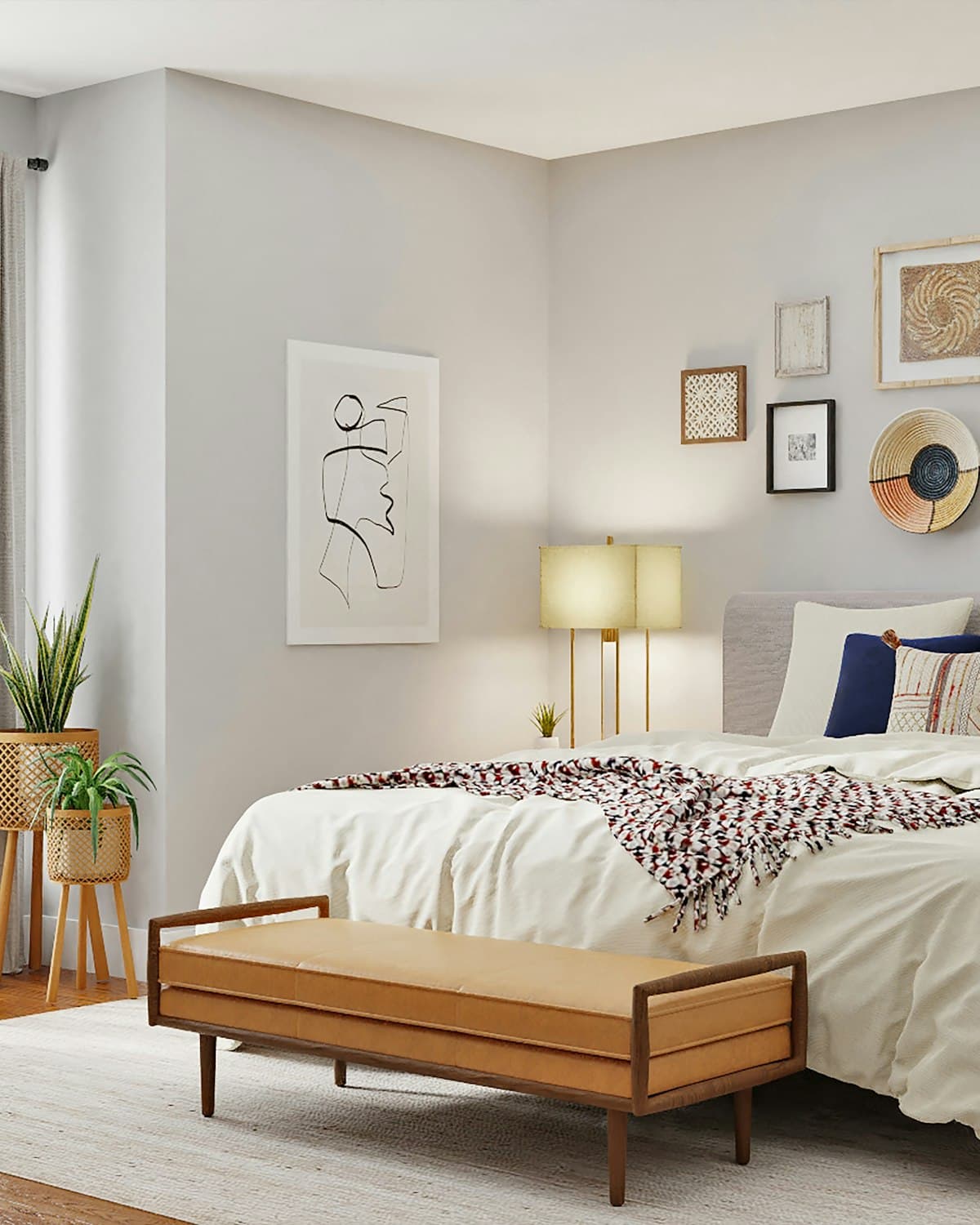 Bright, tidy bedroom with daylight, framed prints and a wooden bench